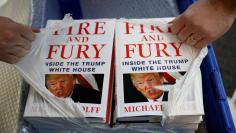 A shop worker opens a package containing copies of Michael Wolff's book 'Fire And Fury' as they go on sale inside a branch of the Waterstones book store in Liverpool, Britain, January 11, 2018. REUTERS/Phil Noble