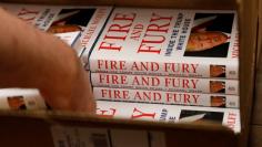 An employee of Book Culture book store unloads copies of "Fire and Fury: Inside the Trump White House" by author Michael Wolff inside the store in New York, U.S. January 5, 2018. REUTERS/Shannon Stapleton
