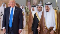 Saudi Arabia's King Salman bin Abdulaziz Al Saud walks with U.S. President Donald Trump during a reception ceremony in Riyadh