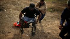 Wheelchair-bound Palestinian demonstrator Ibrahim Abu Thurayeh is pushed before he was killed during clashes with Israeli troops on Friday at a protest near the border with Israel in the east of Gaza City