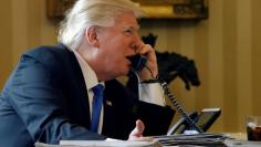 FILE PHOTO --  U.S. President Donald Trump speaks by phone with Russia's President Vladimir Putin in the Oval Office at the White House in Washington, U.S. in this file photo dated January 28, 2017.    REUTERS/Jonathan Ernst/File Photo 
