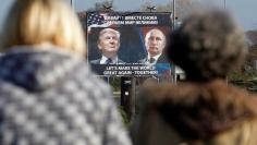 FILE PHOTO: A  billboard showing a pictures of US president-elect Donald Trump and Russian President Vladimir Putin is seen through pedestrians in Danilovgrad, Montenegro, November 16, 2016. REUTERS/Stevo Vasiljevic/File Photo