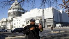 United States Capitol police officer Harry Dunn stops pedestrians in front of the U.S. Capitol in Washington March 29, 2016. REUTERS/Gary Cameron