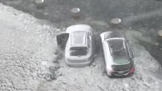 Cars are seen on a flooded street in Boston