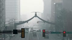 Cars and people move up and down State Street in smog filled downtown Salt Lake City, Utah, U.S. December 12, 2017. REUTERS/George Frey     