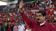 Venezuela's President Nicolas Maduro waves during a pro-government rally with workers of state-run oil company PDVSA, in Barcelona
