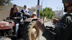 Syria says many vote in assembly election, opposition denounces "show"