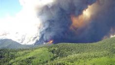 Calmer winds help New Mexico forest fire crews go on offensive