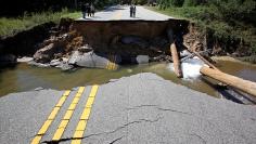 Residents inspect a washed-out section of collapsed road after Hurricane Matthew hit the state, in Fayetteville, North Carolina