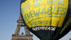 Greenpeace activists fly a hot air balloon depicting the globe next to the Eiffel Tower ahead of the 2015 Paris Climate Conference, known as the COP21 summit, in Paris