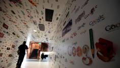 A man walks through a tunnel of Google homepage logos at the Google campus near Venice Beach, in Los Angeles, California January 13, 2012. The 100,000 square-foot campus has around 500 employees who develop video advertising for YouTube, parts of the Goog