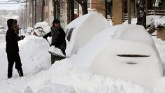 		<p>John O'Connell digs out the car of his girlfriend Katie Decourcelle, which was buried in the snow in Hoboken, New Jersey December 27, 2010. A blizzard pummeled the northeastern United States on Monday, dumping up to 29 inches of snow, disrupting air,