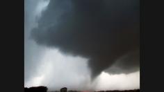 A tornado makes its way over the 135 freeway near Moundridge, Kansas, on April 14, the third day of severe weather and multiple tornado sightings. A spate of tornadoes tore through parts of Oklahoma, Kansas, Nebraska and Iowa, churning through Wichita and