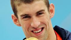 MICHAEL PHELPS GOLD MEDAL - 4th of 8Michael Phelps of the U.S holds his gold medal after winning the men's 200 meters butterfly swimming final at the National Aquatics Center during the Beijing 2008 Olympic Games August 13, 2008. Phelps swam his way into 