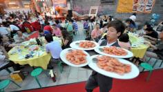People gather at a gourmet festival to experience Taiwanese food in Beijing. Gross domestic product in the world's second-largest economy grew 9.5 percent year-on-year in the second quarter, the National Bureau of Statistics said.